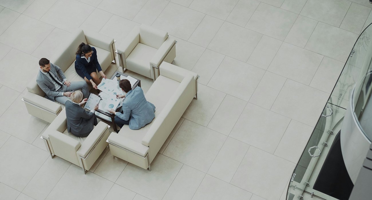 fair work agency people having meeting in bright atrium